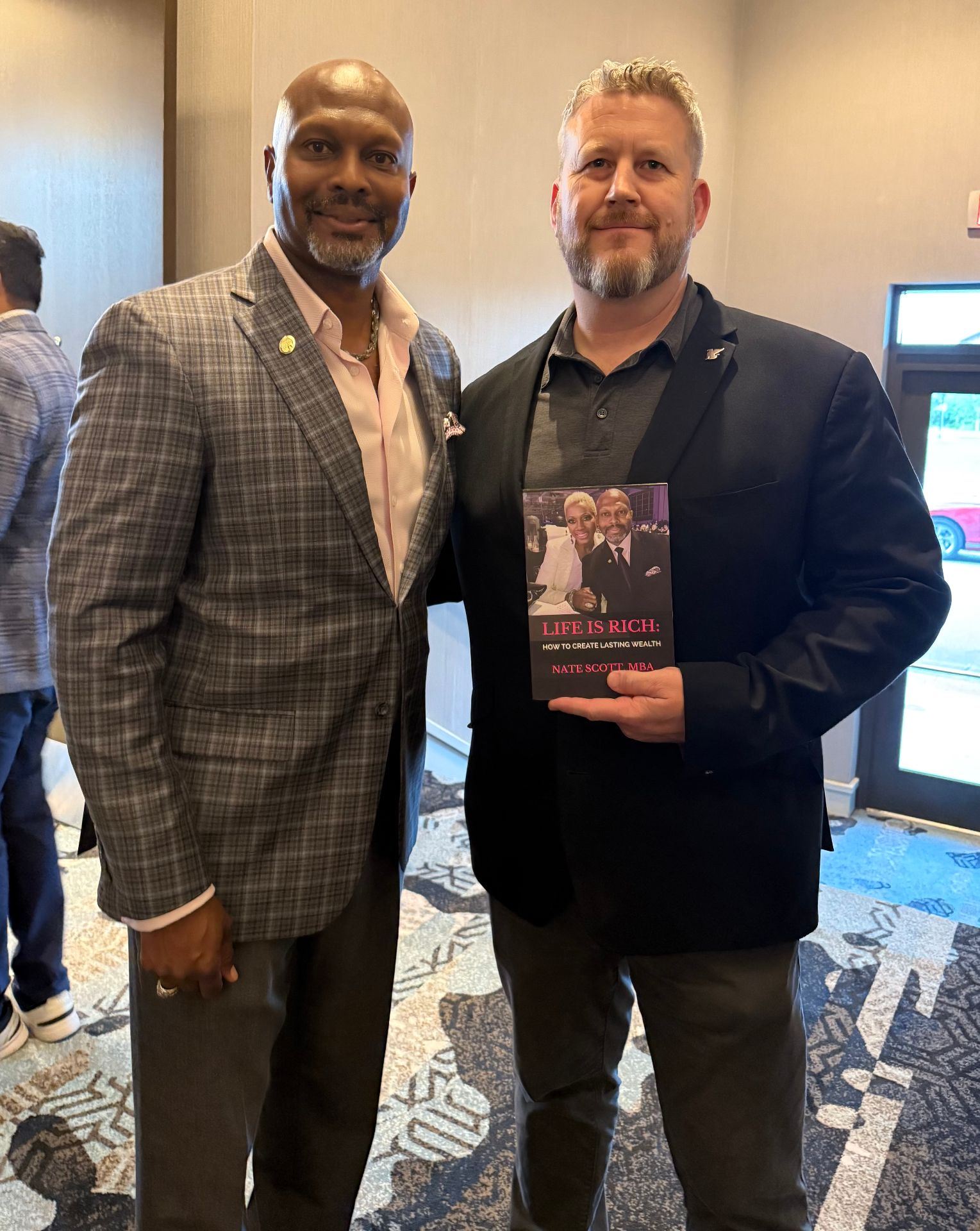 Reader with Nate Scott holding Life Is Rich
