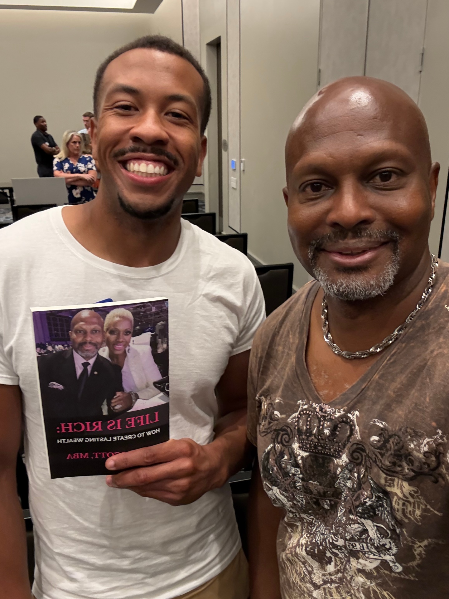 Reader with Nate Scott holding Life Is Rich