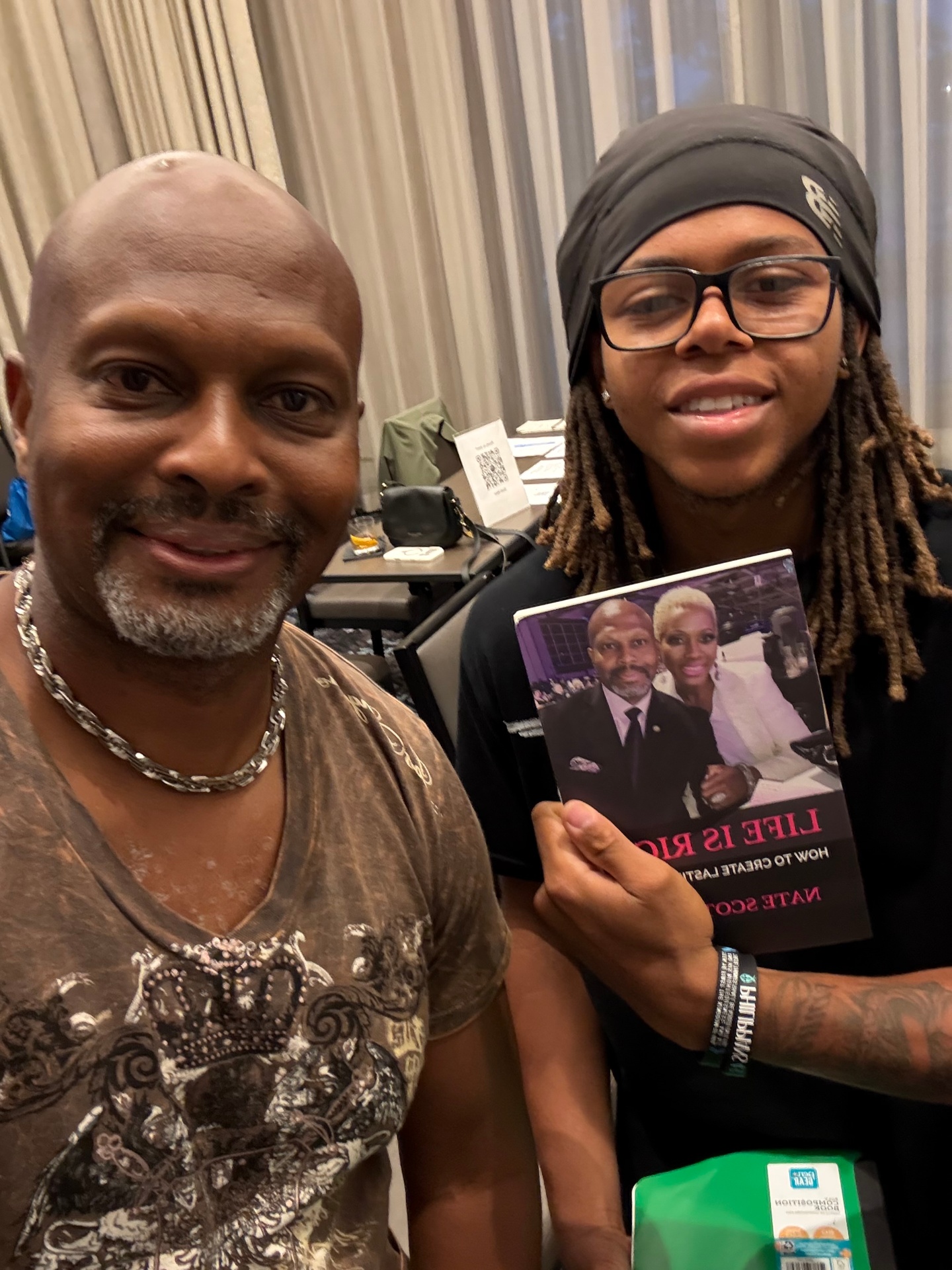 Reader with Nate Scott holding Life Is Rich