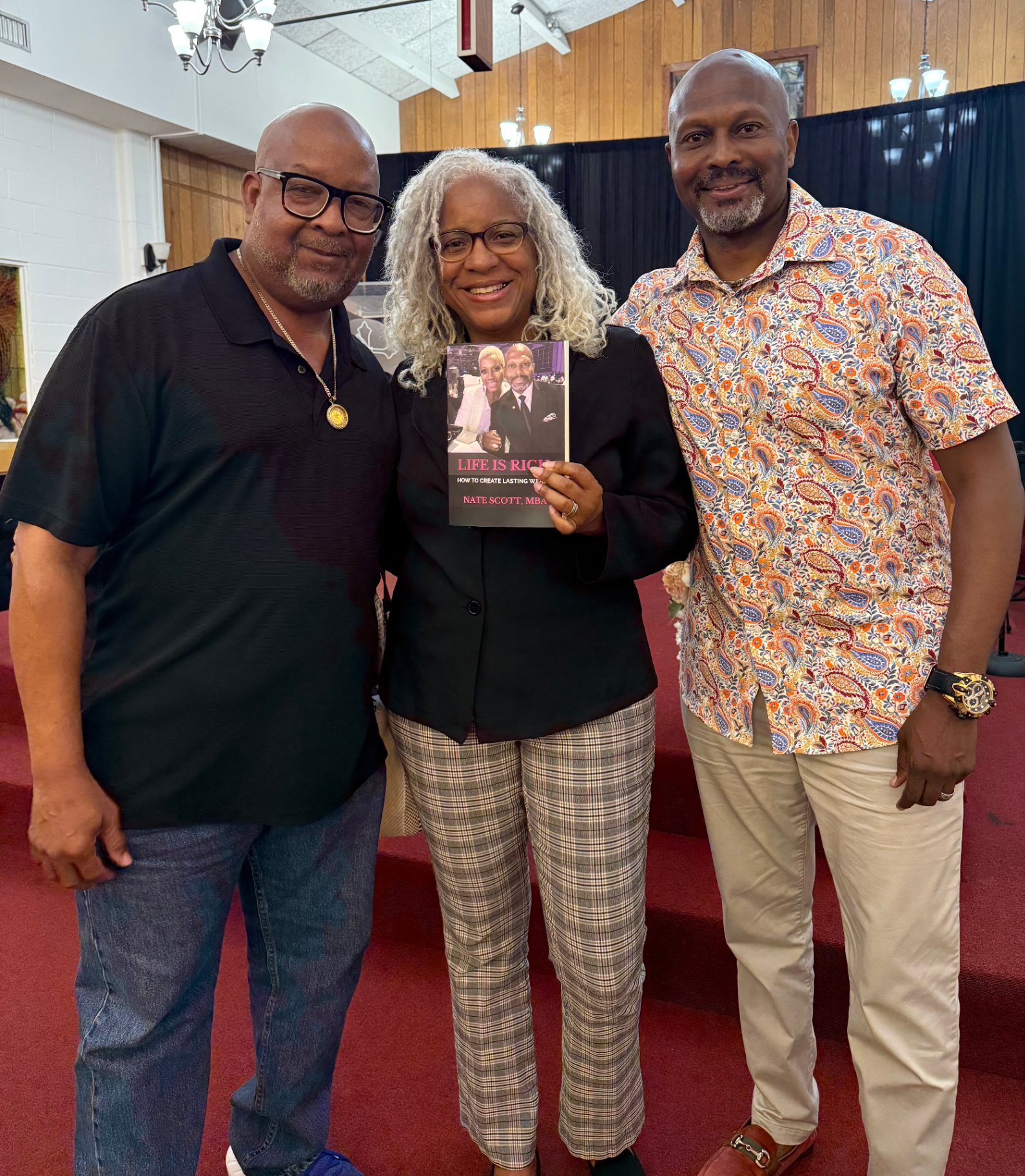 Readers with Nate Scott holding Life Is Rich