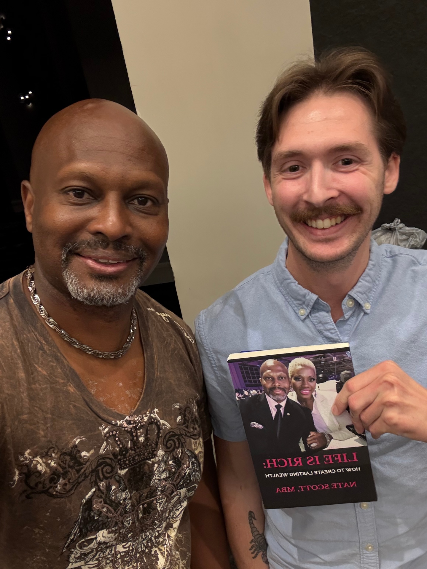 Reader with Nate Scott holding Life Is Rich